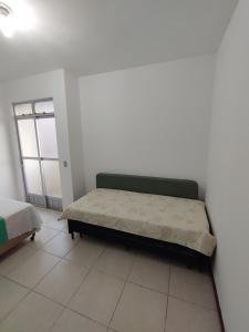 Ένα ή περισσότερα κρεβάτια σε δωμάτιο στο Aconchego Hospital