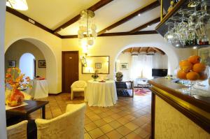 a living room with a table and a dining room at Hotel Al Bosco in Roana