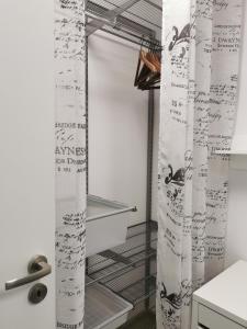 a room with a shower curtain with writing on it at Chic&Chic in Szczecin
