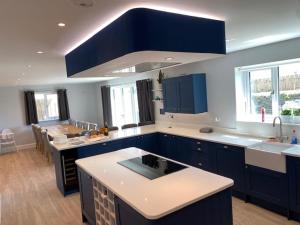 a kitchen with blue cabinets and a counter top at Shackled-Am-Not in Camelford