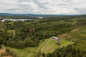 an aerial view of a house on a hill with trees at Cosy private cottage with stunning view in Sunne