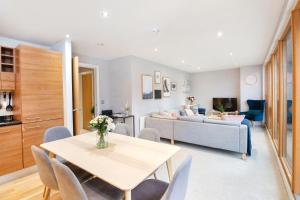 a living room with a table and a couch at Cartier House at the Leeds Dock in Leeds