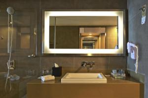 a bathroom with a sink and a mirror at Novotel Chennai Sipcot in Chennai
