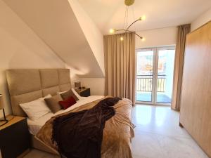 Posteľ alebo postele v izbe v ubytovaní Apartament Royal Szczyrk