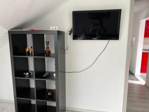 uma televisão pendurada numa parede numa sala de estar em Schwarzwald Appartement Steffanie em Freudenstadt