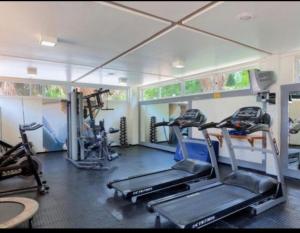 a gym with several treadmills and machines in it at Gran Lençóis Flat Residence in Barreirinhas