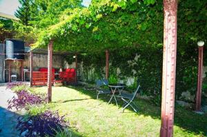 a patio with chairs and a table in a yard at Sofia Rooms in Tivat