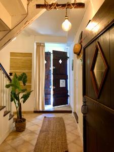 a hallway with a door and a potted plant at Chez Luis et David in Avignonet-de-Lauragais