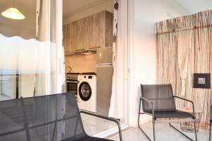 a kitchen with a table and two chairs in a room at Minimal Sea House in Avía