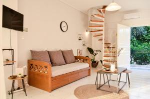 a living room with a couch and a tv at Minimal Sea House in Avía