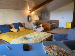 a bedroom with a bed and a living room at Le Prieuré de Saint Pierre in Saint-Pey-de-Castets