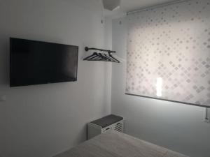 A television and/or entertainment centre at Encantador apartamento residencial con piscina
