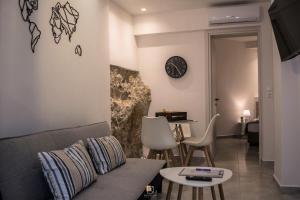 a living room with a couch and a table at Uni Island - Old Town Suites in Heraklio