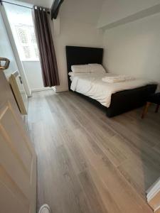 a bedroom with a bed and a wooden floor at Entire One Bedroom Flat, 9 in Great Yarmouth