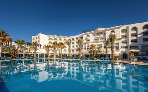 a large swimming pool in front of a hotel at Radisson Blu Resort & Thalasso Hammamet in Hammamet