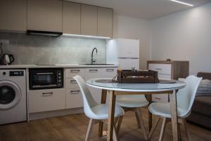 a kitchen with a table and chairs in a kitchen at Uni Island - Old Town Suites in Heraklio