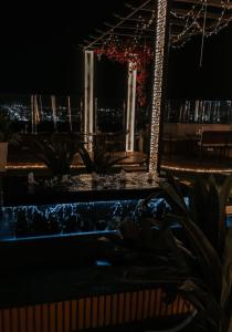 a swimming pool at night with christmas lights at Al Sharq Hotel in Hafr Al Baten