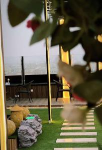 a view of a room with a table and some grass at Al Sharq Hotel in Hafr Al-Batin