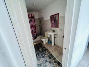 a bathroom with a toilet and a sink at Villa Antonia 16 in Sosúa