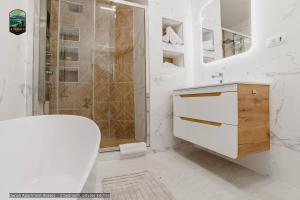 a white bathroom with a toilet and a shower at Sierra - Northstar Apartments in Braşov +53 photos