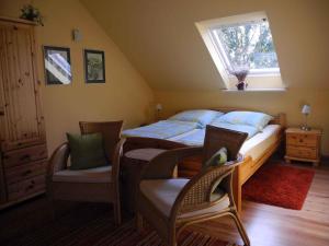 a bedroom with two beds and chairs and a window at Apartments in Vetschau Spreewald 2618 in Vetschau