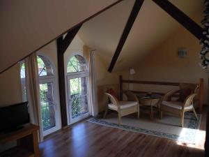 a living room with a table and chairs and windows at Apartments in Vetschau Spreewald 2618 in Vetschau