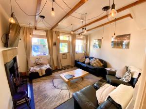 a living room with a couch and a table at The Old Post Office - Giggleswick in Giggleswick