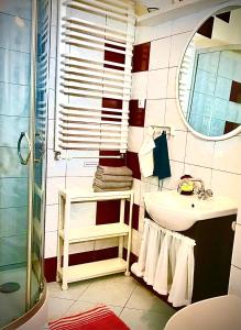 a bathroom with a shower and a sink and a mirror at Kwatera Prywatna Marini in Sopot
