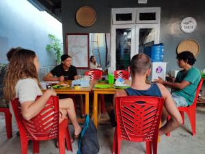 eine Gruppe von Menschen, die um einen Tisch sitzen in der Unterkunft Harry & Mimin Homestay in Gorontalo