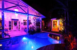 a house with a swimming pool at night at Kuta Blue Lagoon 5 bedrooms Villa near beach and airport in Kuta +38 photos