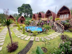 a resort with a swimming pool in the yard at Manik Tirta Cabin's in Kintamani