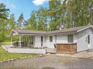a white house with a porch and a patio at 6 person holiday home in Nexø-By Traum in Neksø