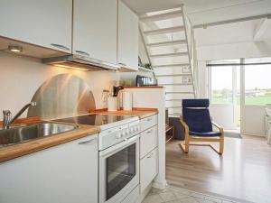 a kitchen with a sink and a stove top oven at Seaside Property in Sandkas in Allinge