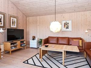 a living room with a couch and a table at 8 person holiday home in Ulfborg in Fjand Gårde