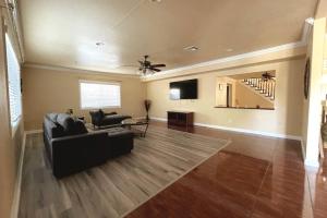 a living room with a couch and a ceiling fan at HUGE GORGEOUS UPGRADED HOME IN THE CENTER OF SOCAL in Loma Linda