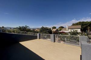 a balcony with a fence and a view of a city at HUGE GORGEOUS UPGRADED HOME IN THE CENTER OF SOCAL in Loma Linda