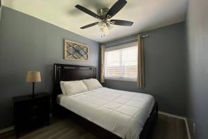 a bedroom with a bed with a ceiling fan at HUGE GORGEOUS UPGRADED HOME IN THE CENTER OF SOCAL in Loma Linda