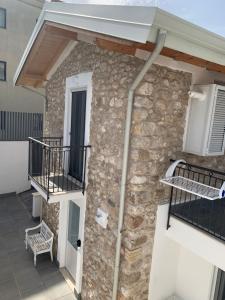 a house with a stone wall and a balcony at LA CASA DI PIETRA in Formia
