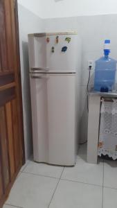 a white refrigerator in a corner of a kitchen at Casa Azul Gamboa in Gamboa