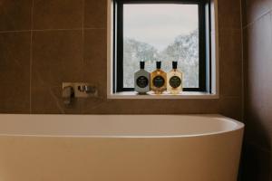 three bottles of wine sitting on a window sill at Kunama Townhouses in Jindabyne +27 photos