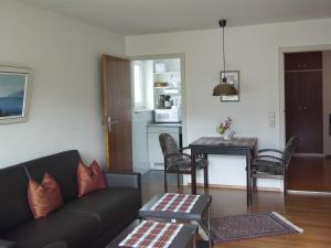 a living room with a couch and a table at Ferienwohnung Breitenbergblick in Pfronten