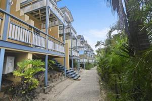 a walkway leading up to a row of apartment buildings at Villa 52 Tangalooma in Tangalooma