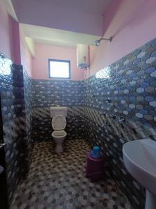 a bathroom with a toilet and a sink at Wind Valley Homestay in Pelling