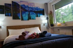 two stuffed animals are sitting on a bed at Window on the mountains in Breuil-Cervinia