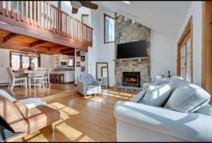 a living room with a couch and a fireplace at Cabin at poconos,spa-room with Hot tub, grill, fire pit in Miami