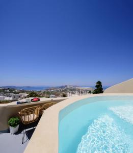 a swimming pool on the roof of a building at Diva Santorini Luxury Villa in Pyrgos