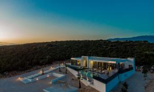 an aerial view of a house with a sunset at Villa Porta Novalja in Novalja