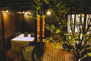 a bathroom with a sink and a tree at SAUNA FOREST CABIN 軽井沢 御代田　MORI-ASOBI in Oiwake