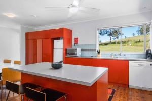 a kitchen with orange cabinets and a white counter top at Yarramie in Mount View