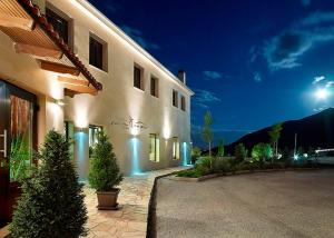 a building with christmas trees in front of it at night at Orfeas Land in Kormísta